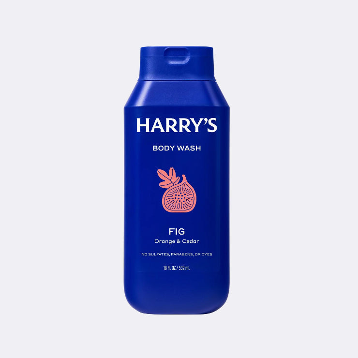 Blue bottle of Harry's body wash with Fig illustration on a light gray background