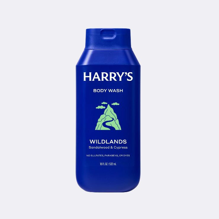 Blue bottle of Harry's Wildlands body wash on a light gray background
